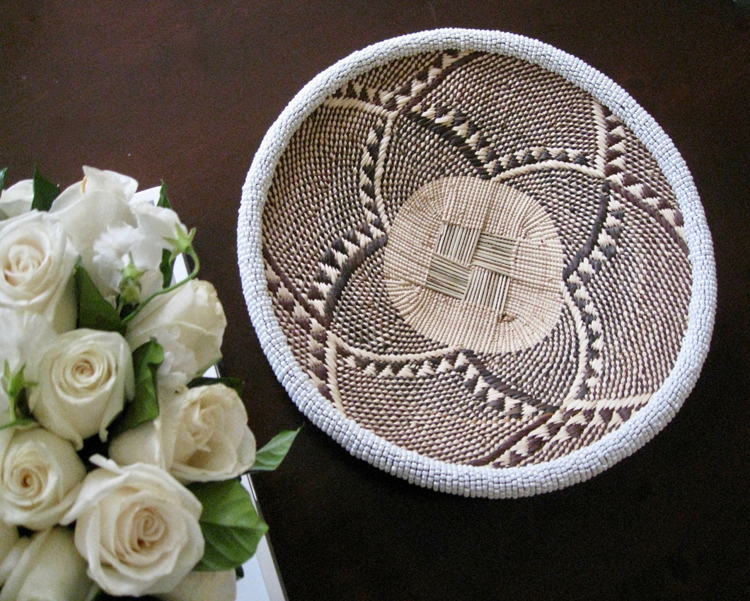 Small handwoven floral designed basket with white beading 