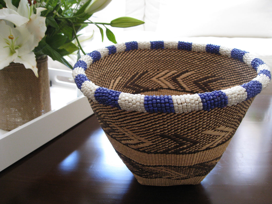 Handwoven bucket basket with purple and white beading around the rim
