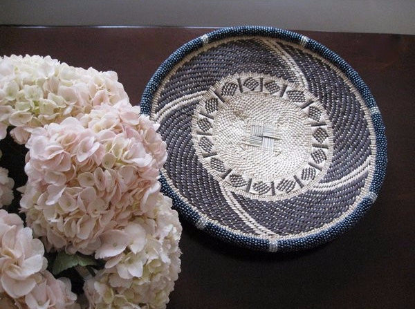 Small handwoven dark gray and white beaded basket